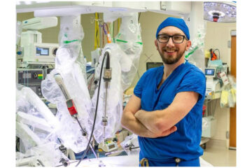 Dr. Mitzman with da Vinci 5 robotic surgical system. Image Credit: Emily Bade